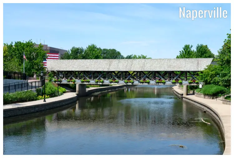 A covered bridge over a river along the famous Naperville Riverwalk in Naperville, Illinois A covered bridge over a river along the famous Naperville Riverwalk in Naperville, Illinois