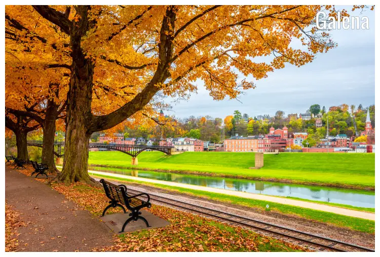 Bright brown and golden trees near a calm river, bridge, and the colorful town of Galena, Illinois, Bright brown and golden trees near a calm river, bridge, and the colorful town of Galena, Illinois,