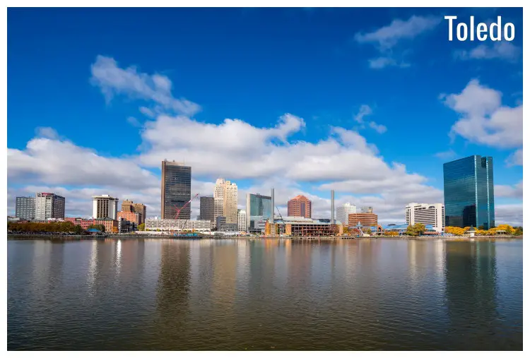 Tall buildings of the skyscape of the scenic Toledo City, in Ohio, seen across Maumee River