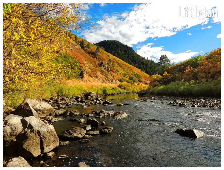 The hilly slopes on the South Platte River during the fall, large rocks, and stones in the river below The hilly slopes on the South Platte River during the fall, large rocks, and stones in the river below