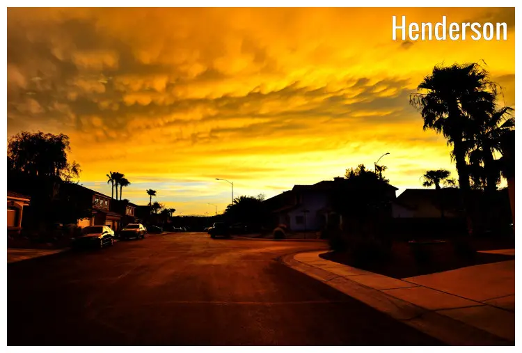 A dramatic yellow and the grey sky is hung overhead in a small town in Henderson, Nevada, during a scenic sunset