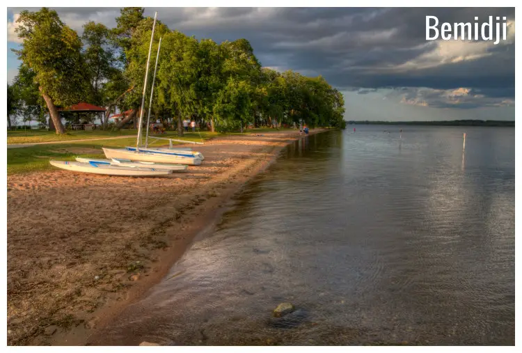 Shallow waters and brown sandy shores with empty vessels along Lake Bemidji, Minnesota