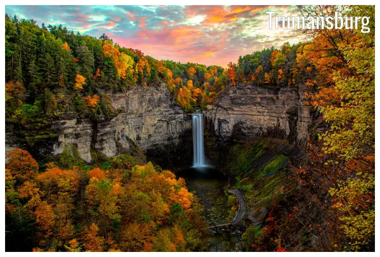 The stunning full colors of the fall in the red, brown, and golden trees around the scenic high Taughannock Falls in Trmansburg, New York