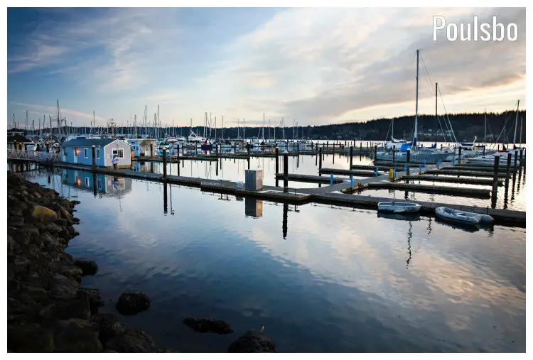 Numerous sailboats and yachts dock along the many piers on the water in the marina at Poulsbo, Washington