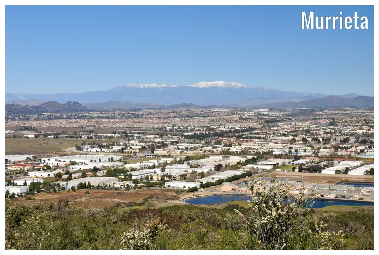 The dense city of Murrieta in California, with a far view of hills and snow-covered mountains