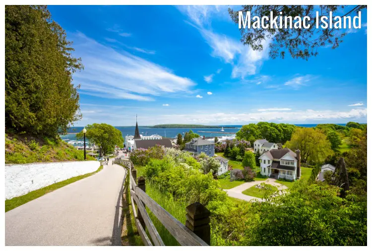 A tranquil neighborhood with homes and a church in a scenic natural park in Mackinac Island, Michigan