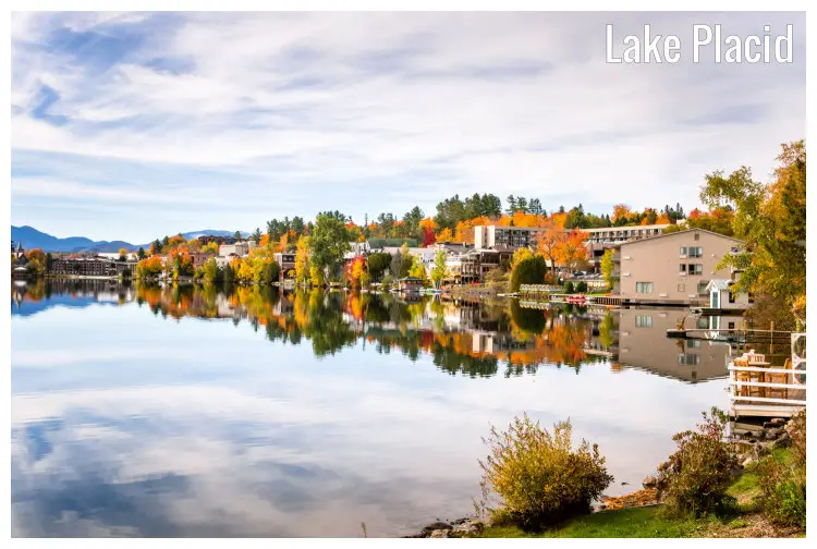 A beautiful image, taken in the fall, of scenic golden and brown trees in the Mountain Village along with Lake Placid, New York