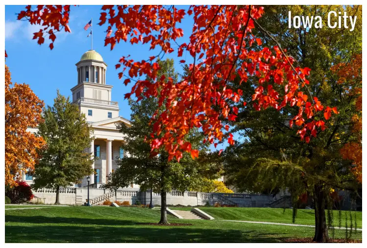 Golden and brown trees in a scenic, neat lawn near the mighty grandeur of the Old Capitol building, Iowa City