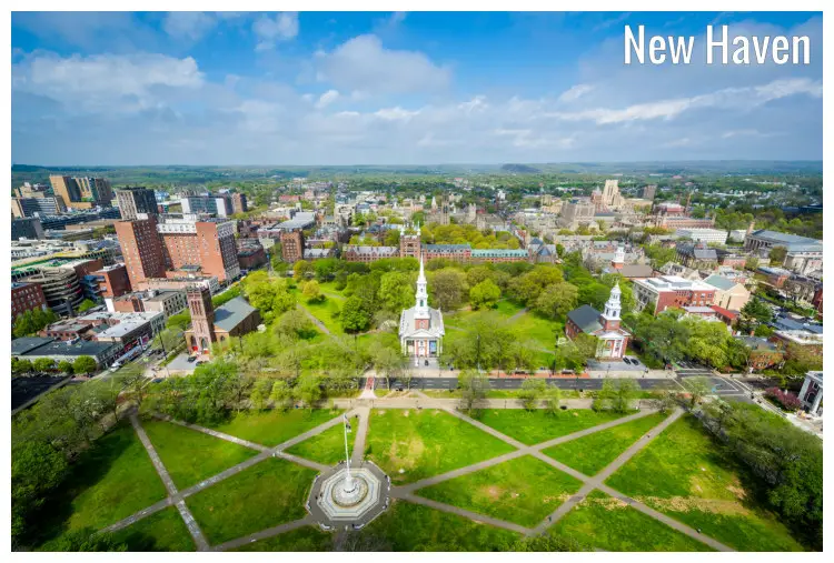The greeny New Haven Green in Connecticut, with the rest of the city and a far away dramatic landscape