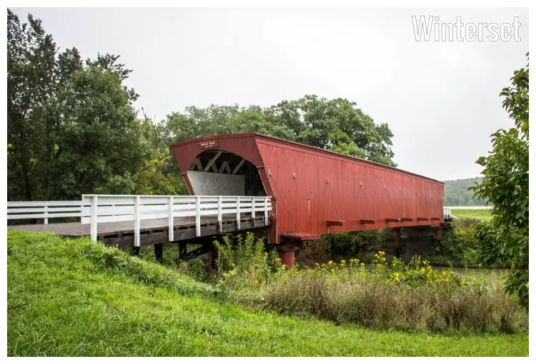 A historic Hogback Covered Bridge in Winterset in Madison County, within Iowa A historic Hogback Covered Bridge in Winterset in Madison County, within Iowa