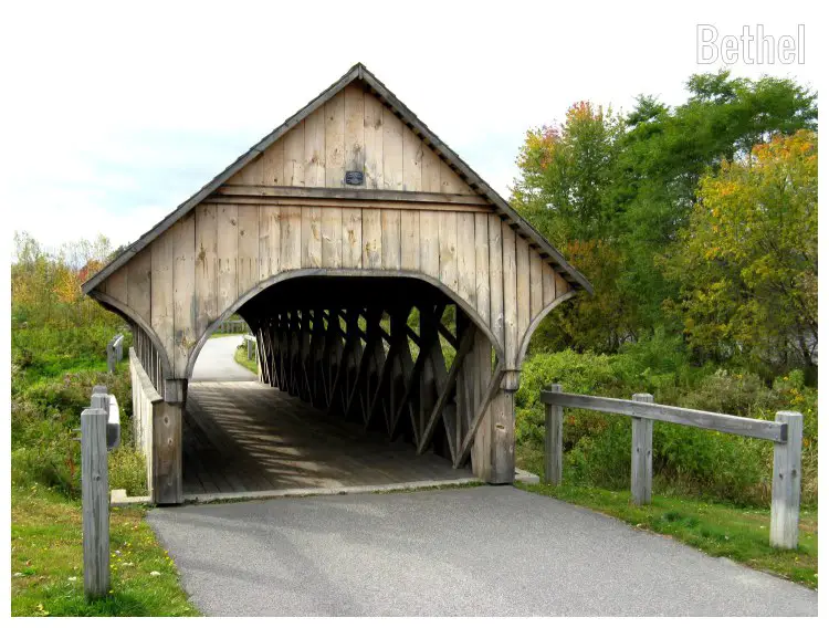 A wooden closed bridge with beautiful yellow and green trees on both sides in Bethel, Maine A wooden closed bridge with beautiful yellow and green trees on both sides in Bethel, Maine