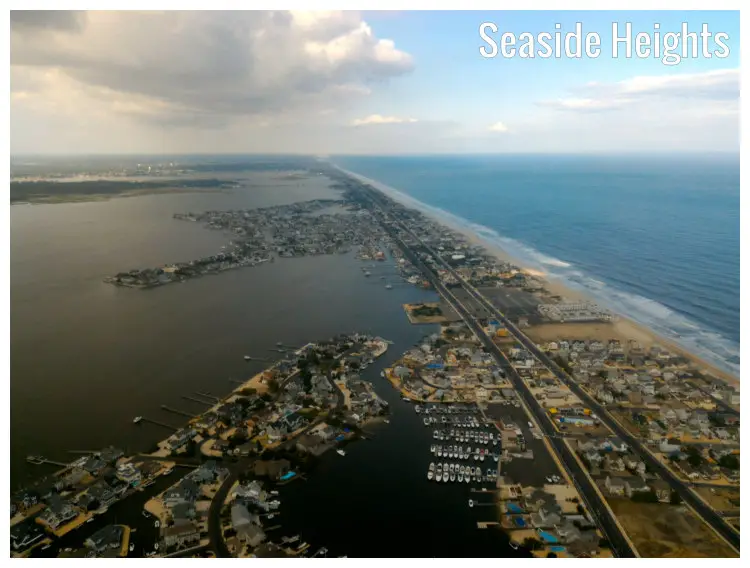Seaside homes and boats docked along numerous piers and a long and endless road along the town of Seaside Heights in New Jersey