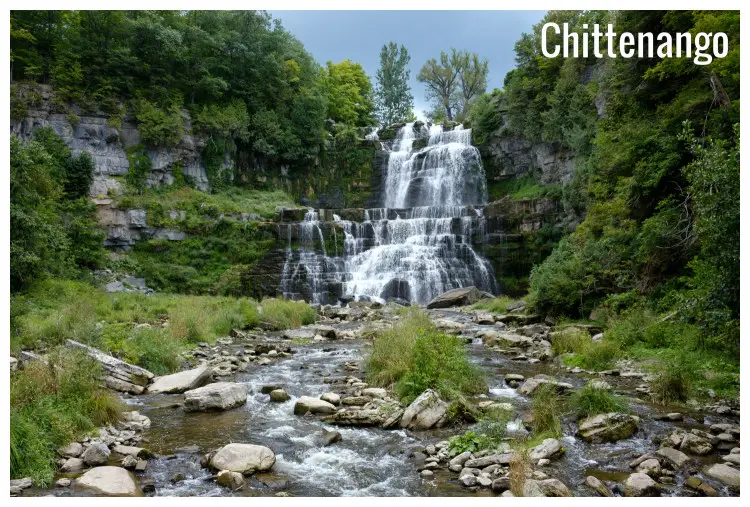 A high waterfall drops over the cliff rocks into the rocky, shallow river below in the Chittenango Falls State Park, New York, A high waterfall drops over the cliff rocks into the rocky, shallow river below in the Chittenango Falls State Park, New York,