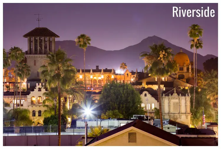 The neon-lit buildings of Riverside, California, and a silhouette of the high mountain in the back The neon-lit buildings of Riverside, California, and a silhouette of the high mountain in the back