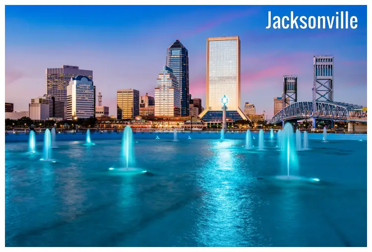 Water geysers at the fountain of Jacksonville in Florida, USA, with the cityscape Water geysers at the fountain of Jacksonville in Florida, USA, with the cityscape