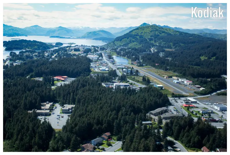 Natural forests, mountains, and distant hill ranges surrounding the small town of Kodiak in Alaska