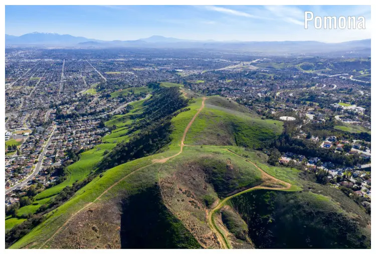 Trails in the rural mountainous region of Pomona, California, with scenic slopes and dense population down below