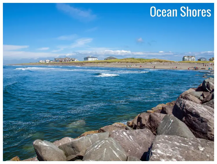 Standing on the large rocks on the shore, this tranquil spot offers sweeping views of the Ocean Shore in Washington, visible across the water Standing on the large rocks on the shore, this tranquil spot offers sweeping views of the Ocean Shore in Washington, visible across the water
