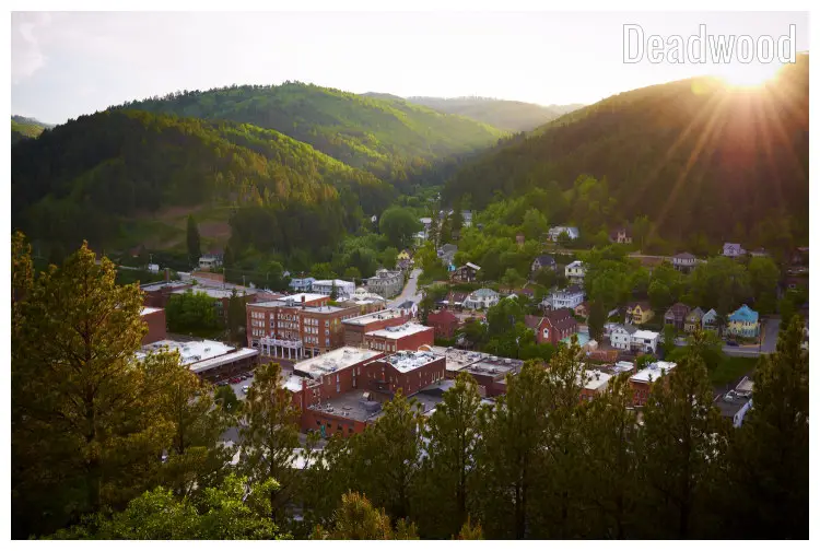 The warm setting sun has its rays spread over the scenic landscape in the colorful town of Deadwood, South Dakota The warm setting sun has its rays spread over the scenic landscape in the colorful town of Deadwood, South Dakota