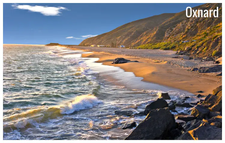 Light waves on the soft sand and rocks of the scenic Ocean Beach in Oxnard, California