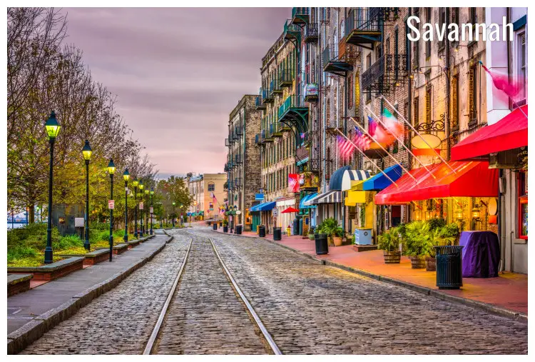A railway track through a well lit River Street in Savannah, Georgia A railway track through a well lit River Street in Savannah, Georgia