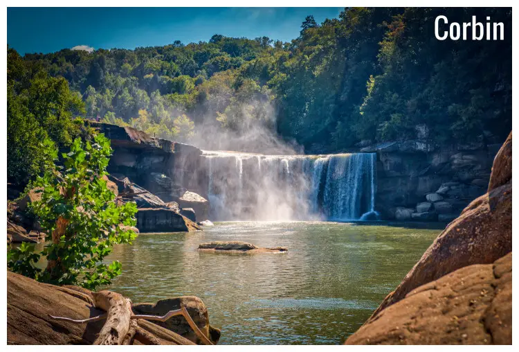 High rock cliffs and dense tree cover around the scenic waterfall in Cumberland Falls State Park in Corbin, Kentucky