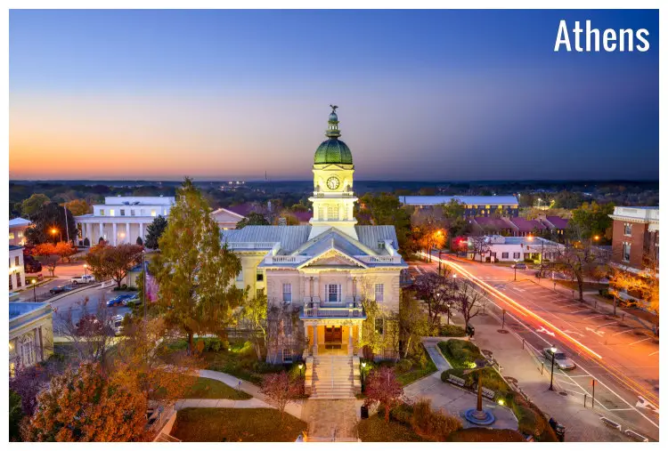 The historic city hall tower at dusk in Athens, Georgia, along with other neon-lit houses in the vicinity