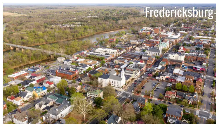 A river Rappahannock gloriously flows separating bushy trees from the beautiful buildings in Fredericksburg city, Virginia A river Rappahannock gloriously flows separating bushy trees from the beautiful buildings in Fredericksburg city, Virginia
