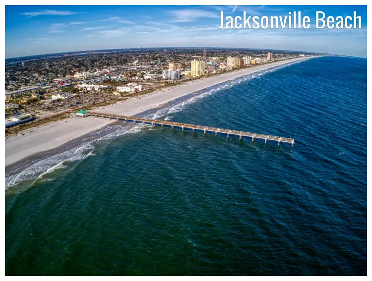 A long pier on the scenic blue water and white sand Jacksonville Beach in Florida, with a vast view of the long Atlantic coast A long pier on the scenic blue water and white sand Jacksonville Beach in Florida, with a vast view of the long Atlantic coast