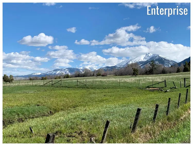 Broken fences in grass fields at the foot of the iconic Wallowa Mountain in Enterprise, Oregon Broken fences in grass fields at the foot of the iconic Wallowa Mountain in Enterprise, Oregon