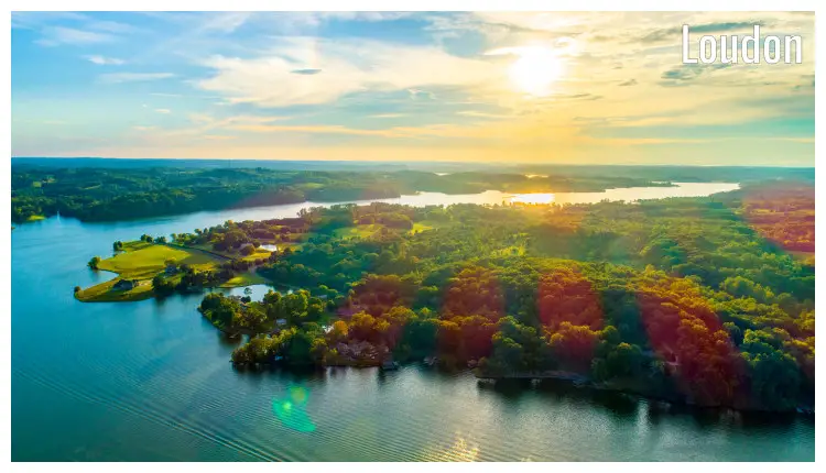 A tranquil scene as the rays of the setting sun seeps through the amazing landscape in the hilly region in Loudon, Tennessee A tranquil scene as the rays of the setting sun seeps through the amazing landscape in the hilly region in Loudon, Tennessee
