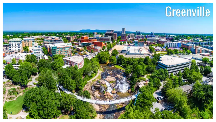 The scenic Greenville City of South Carolina, with a view of the curved bridge over a small river flowing through the city The scenic Greenville City of South Carolina, with a view of the curved bridge over a small river flowing through the city