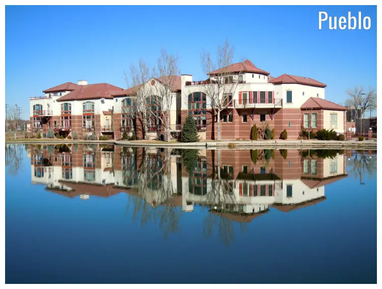 A scenic mirror image of a colorful red and white condo in Pueblo, Colorado A scenic mirror image of a colorful red and white condo in Pueblo, Colorado