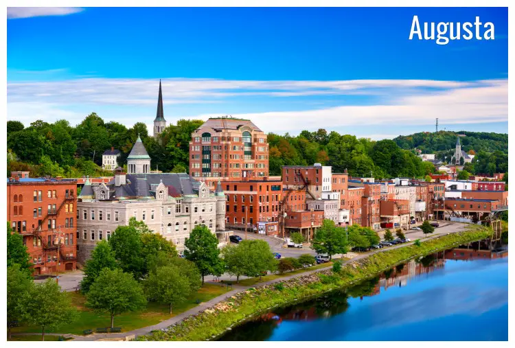 Beautiful view of the water and skyline in Augusta, Maine, with trees and mountains in a distance
