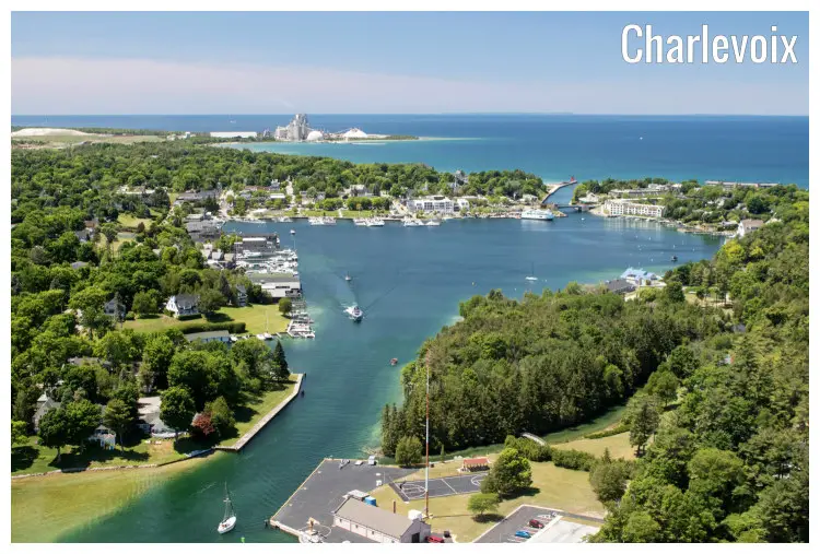 Round Lake in Charlevoix, Michigan, with a view of its entry and exit rivers, and a scenic tree cover around it, the sea is outback Round Lake in Charlevoix, Michigan, with a view of its entry and exit rivers, and a scenic tree cover around it, the sea is outback
