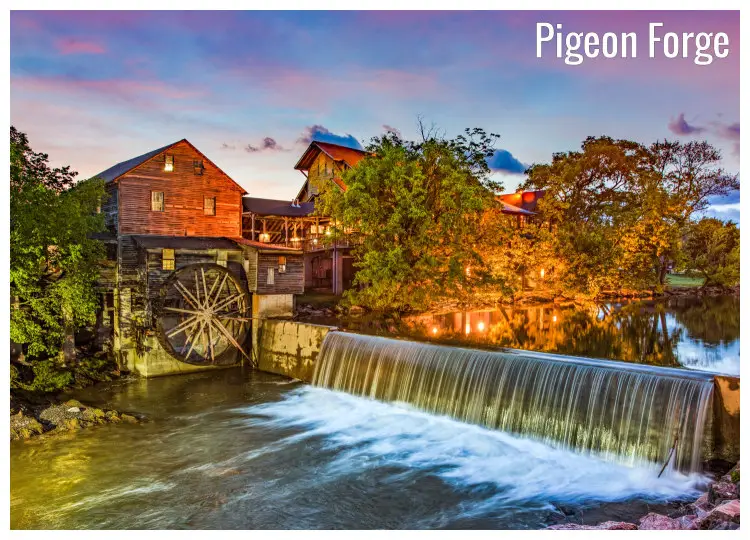 The Old Mill with a scenic water view in Pigeon Forge, Tennessee, with bright neon lights seen among the trees and old wooden houses The Old Mill with a scenic water view in Pigeon Forge, Tennessee, with bright neon lights seen among the trees and old wooden houses