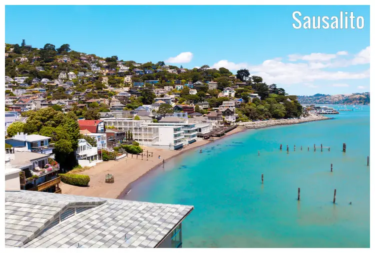 The colorful waterfront homes and the hilly region over the clear blue water of the ocean, Sausalito, California