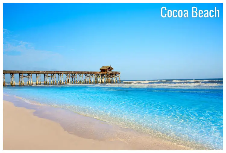 A high pier with a shed on the stunning Cocoa Beach in Florida with white sands and blue water, mild waves, and a sweet clear sky A high pier with a shed on the stunning Cocoa Beach in Florida with white sands and blue water, mild waves, and a sweet clear sky