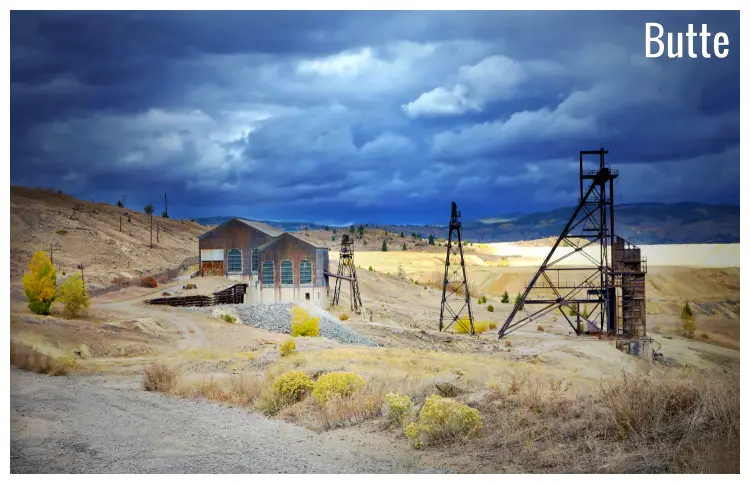 Houses and old frames in an open space that is a former mine ground in Butte, Montana