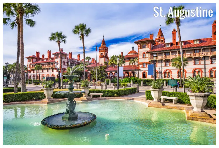 Palm trees and colorful houses in front of water fountains in a popular town square in St. Augustine, Florida