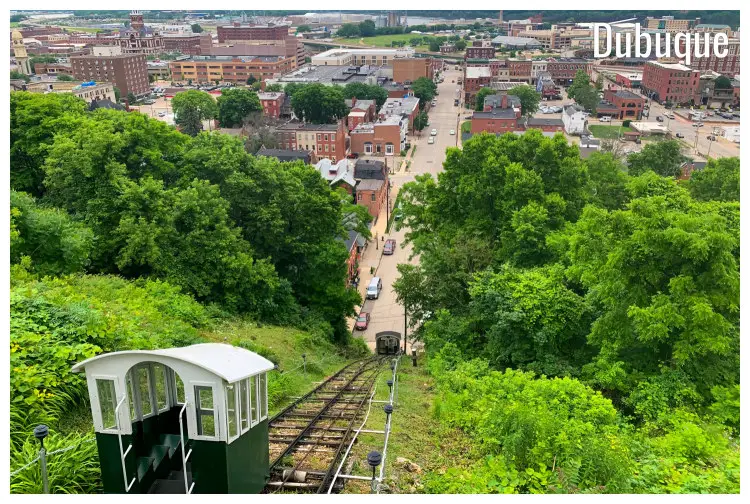A small railway line in Dubuque, Iowa, set on a hilly and scenic greenery spot overlooking the brown buildings in the rest of the city