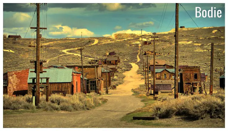Old houses, lone streets, and beat electric poles in the old ghost town of Bodie, California