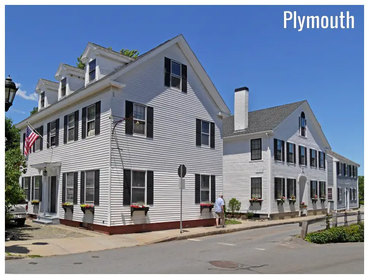 The white colonial houses in Plymouth, Massachusetts, with the US flag flying The white colonial houses in Plymouth, Massachusetts, with the US flag flying