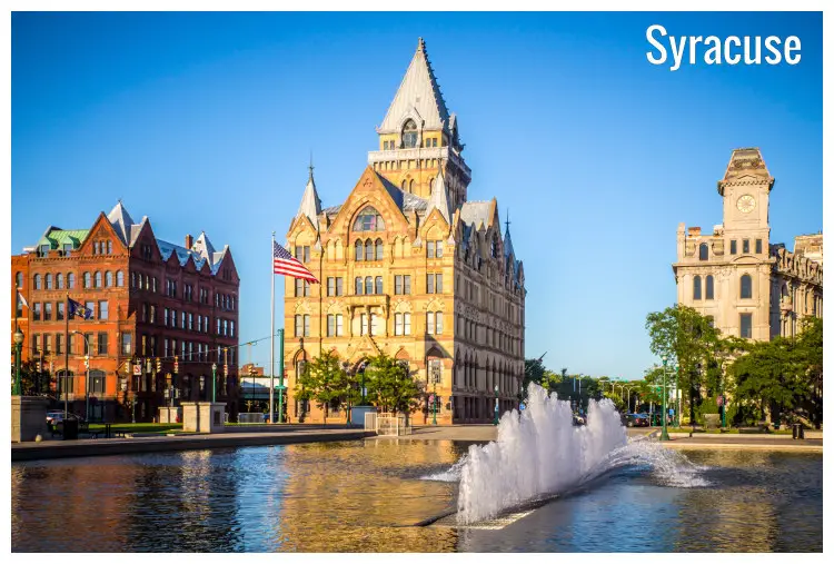 A water fountain in the Clinton Square in Syracuse, New York, with a view of towering historical buildings
