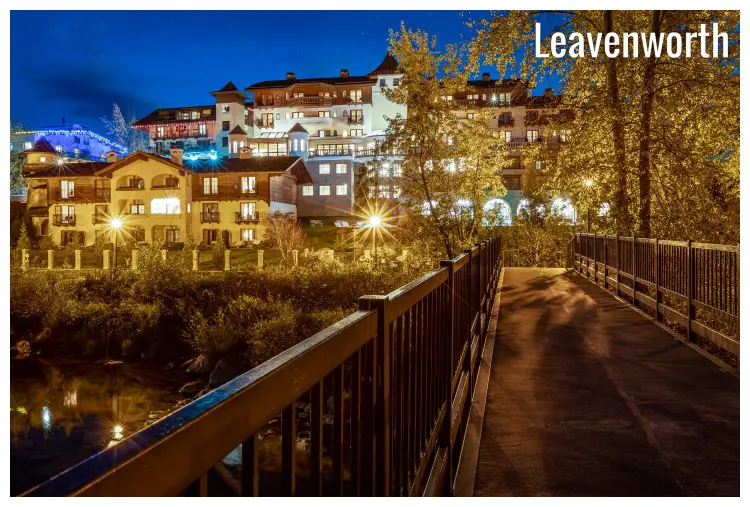 A bridge across a small river heads up to the classy Posthotel in Leavenworth, Washington