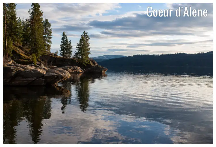 Rocks, trees, and mountains on the shores of Lake Coeur d