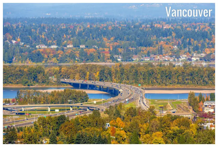 The intricate design of the road acting as a bridge over a calm, blue river in Vancouver, Washington
