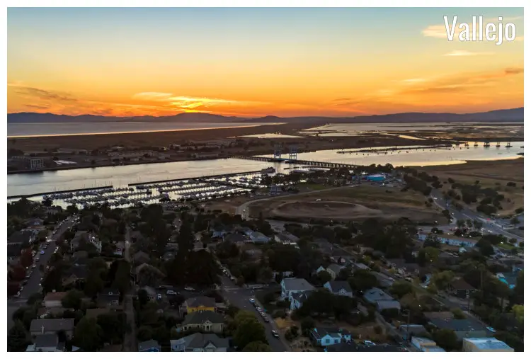 A colorful orange sunset skyline seen over the Napa River and Bridge in Vallejo, California