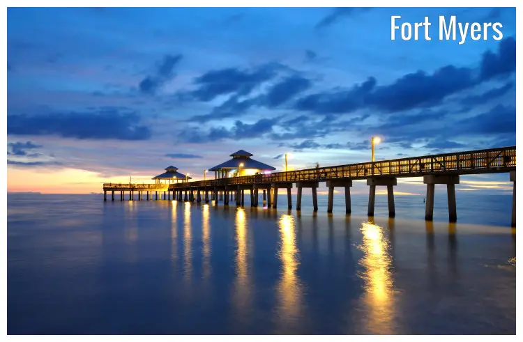Dusk over the pier bridge in Fort Myers, Florida, with cloudy skies and calm waters below