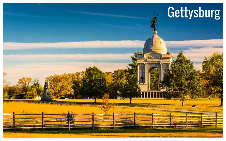 The iconic and unifying Pennsylvania monument in a vast green field with neat grounds and green trees in the city of Gettysburg, Pennsylvania
